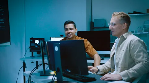 Two young male IT software developers high five celebrating successful syst.. Video stock 337084197