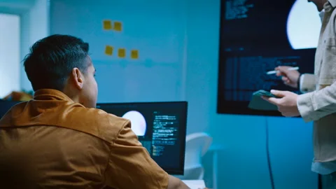 Two young male IT software developers discussing and planning system code w.. Stock Footage 337085250