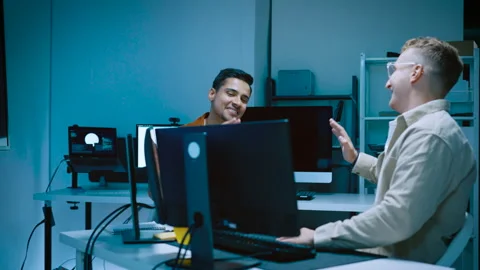 Two young male software developers giving high five celebrating successful .. Stock Footage 337081191