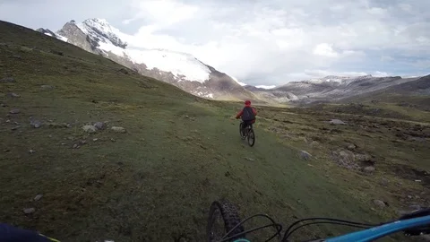 Two Young Males Mountain Biking Towards A Glacier On A Trail In An Alpine Landsc Stock Footage 78250729