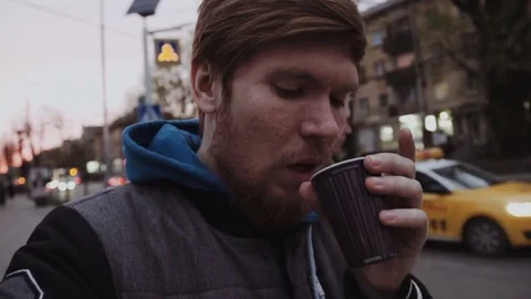 Two young man with a beard walking through the city and shooting themselves Stock Footage 75636417