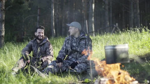 Two young man hunters or tourists near forest. Summer vacation forest. Friends Stock Footage 133260357