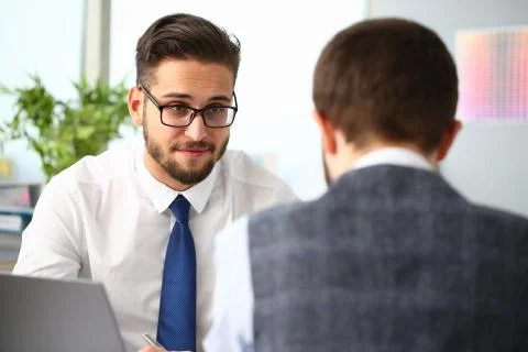 Two young managers discussing their business plan Stock Photos