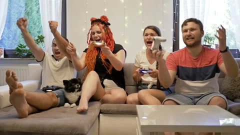 Two young married couples compete with each other in computer games. Excitement Stock Footage 136285900