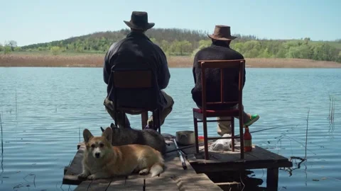 Two young men and their dogs fishing from the pier. Stock Footage 241178286