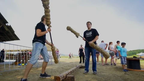 Two young men are trying to fight with big objects Stock Footage 70133918