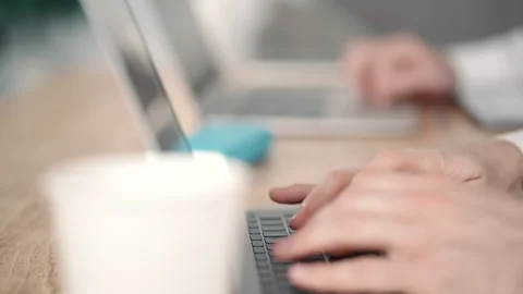 Two young men are working on startup project at table with laptops in modern Stock Footage 130802020