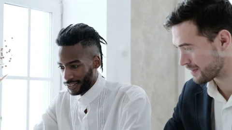 Two young men discussing start-up ideas, laughing and smiling. Stock Footage 100726299