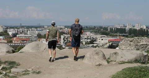Two young men enjoying view at ancient Nebet Tepe ruin of Plovdiv Stock Footage 93891030