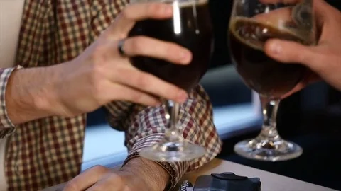 Two young men friends sitting in bar and talking with each other while drinking Vídeos de archivo 85172197