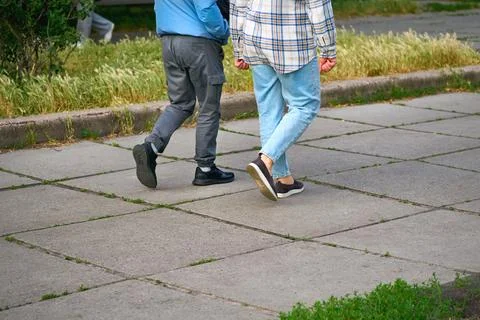 Two young men go about their business in casual clothes Stock Photos