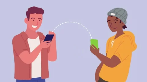 Two young men interacting using their smartphones to share data wirelessly .. Stock Footage 339056826