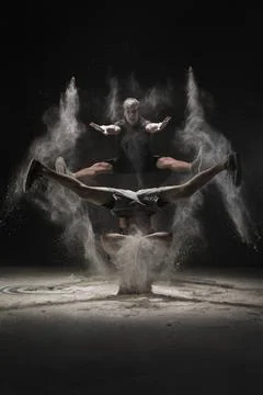 Two young men jumping in cloud of white dust view Two young men in sportsw... Stock Photos