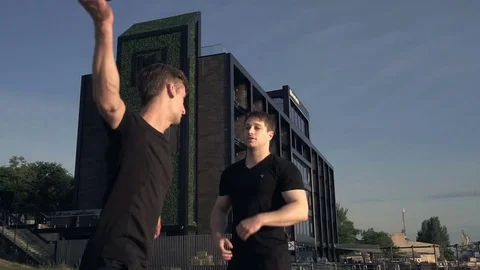 Two young men with knife fight training against sunrise in slow motion Stock Footage 77783118