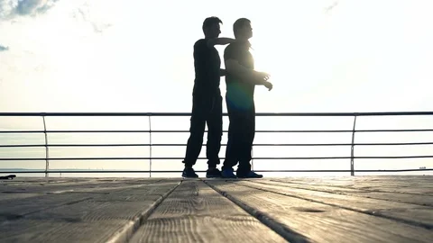 Two young men with knife fight training against sunrise in slow motion Stock Footage 77783915