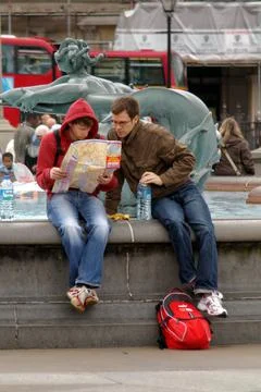 Two young men looking at a map of London. Stock Photos