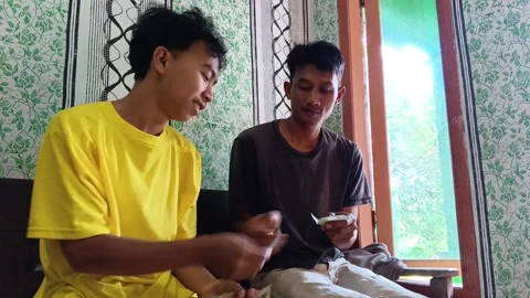 Two young men making a cash transaction indoors. Stock Footage 317981114