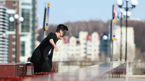 Two young men performing acrobatic parkour tricks and somersault in the end Stock Footage 106859953