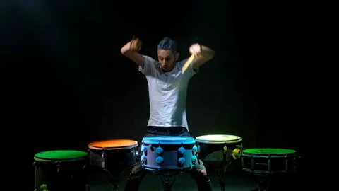 Two young men playing the drum. Colored holi powder Stock Footage 102728412