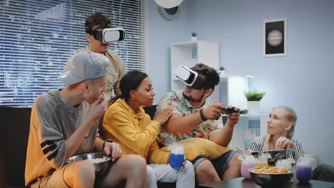 Two young men playing online game in virtual reality glasses, one guy wins the Video stock 153092580