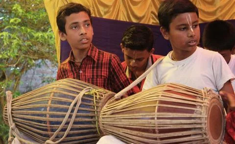 Two young men playing traditional drums in a village in India Stock Photos