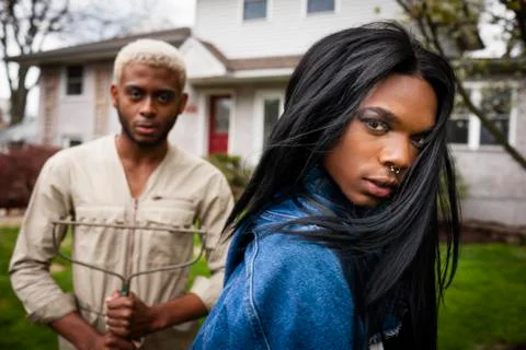 Two young men posing in front yard Stock Photos