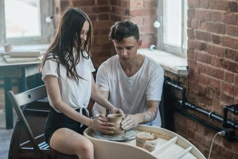 Two young men in a pottery workshop make a jug Stock Photos