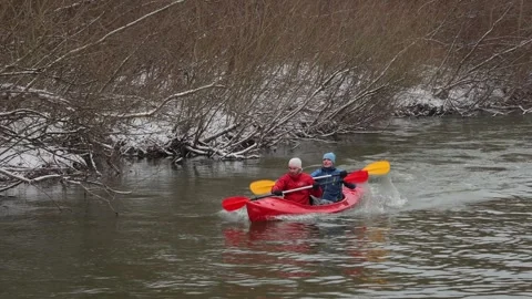 Two young men rowing purposefully in a red kayak. Stock-Footage 301553282