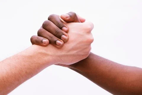 Two young men shaking hands, close-up, studio shot Stock Photos