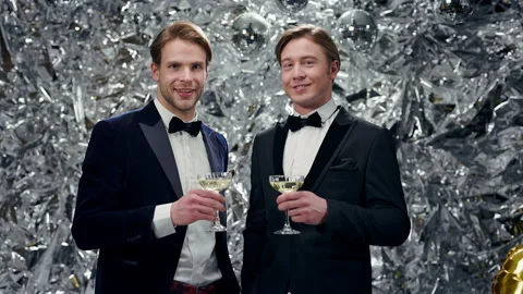 Two Young Men On Shiny Background With Glasses Of Champagne. Party. Stockbeeldmateriaal 179062099