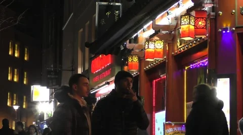 Two young men standing outside restaurant in china town Stock Footage 46958518