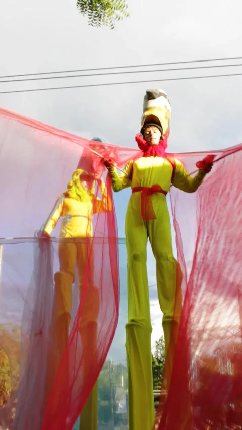 Two young men on stilts in a folklore parade Stock Footage 312410317
