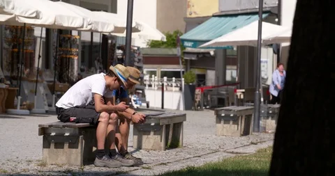 Two young men with straw hats using their smart phone, Germany 4K Stock Footage 114434702