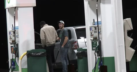 Two Young Men Talking at Gas Station - 4k Stock Footage 68852225