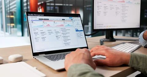 Two Young Men Use QMS Software For Quality Control And Process Improvement. Stock Photos