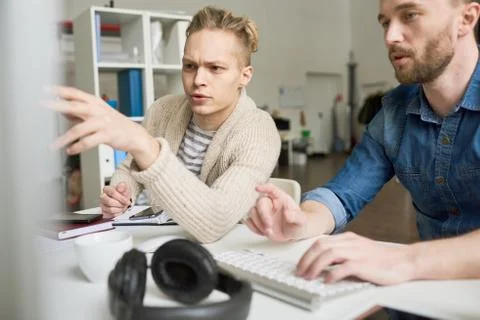Two Young Men Using Computer in Office 스톡 사진