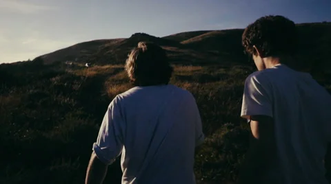 Two Young Men Walking During Sunset. 120fps Stock Footage 64640914