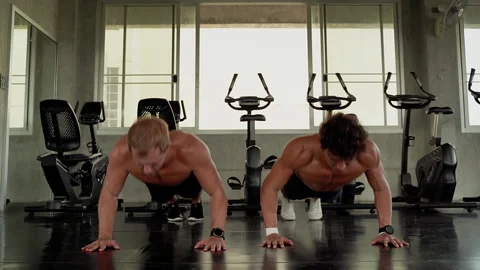 Two young men who are friends, do push-ups and do High Five.Show friendship Stock Footage 132270831