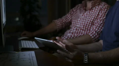 Two young men work with the tablet and the computer Stock Footage 58014492