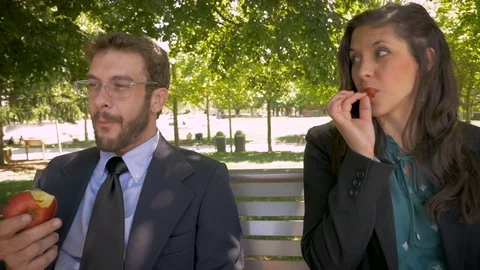 Two young millennial office executives eating healthy fruit outside close up Video stock 78230028