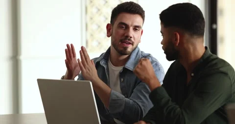 Two young multiethnic teammates using laptop working on joint task Stock Footage 262906551