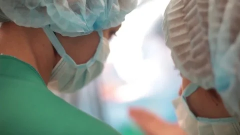 Two young nurses stand in the operating room and communicate Video stock 70807294
