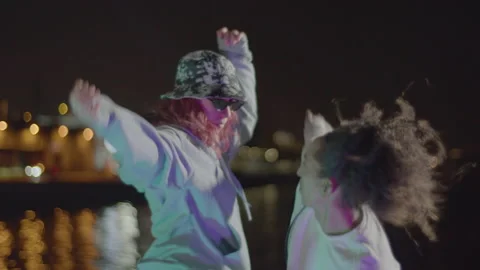 Two young people dancing at seafront at night Stock-Footage 232424202