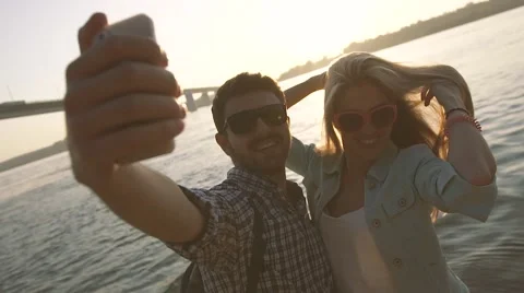 Two young people in love having fun on the river bank 库存影片 68096313