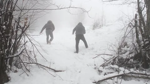 Two young people playing snowballs Stock Footage 265489255