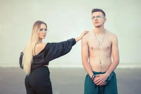 Two young people posing outside in street style clothes Stock Photos