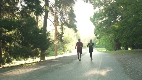 Two young people running in a forest 動画素材 76223637