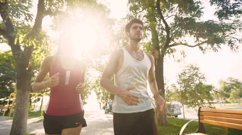 Two young people training for marathon on beautiful park near the sea Video stock 68857964