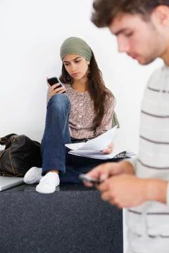 Two young people using mobile phones Stock Photos