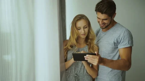 Two young people using tablet at home Stock Footage 68721314